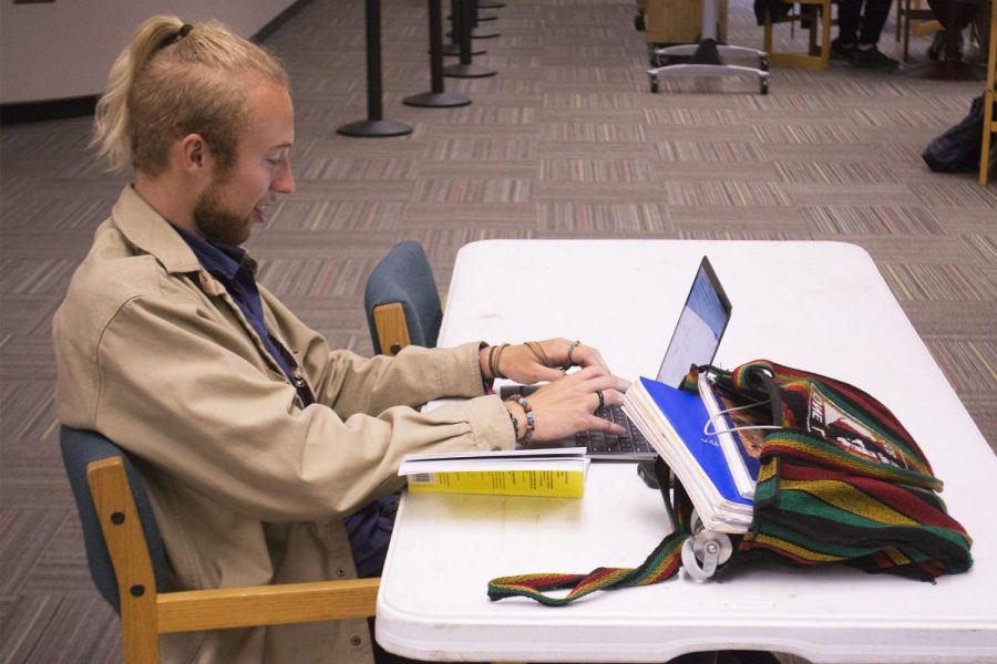 City College student Pierce Glover writes an essay for his English class in the Luria Library on Thursday, April 18, 2019 on West Campus at Santa Barbara City College.