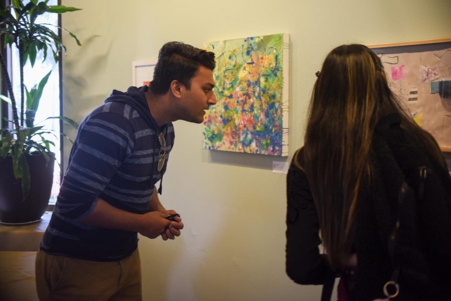 Romit Mukherjee looks at the Non-Objective Art exhibit on Tuesday, April 2, 2019, in the John Dunn dining hall at City College in Santa Barbara, Calif.