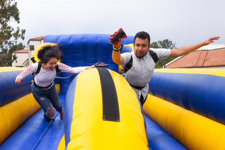 Samantha Cazares and Carlos Barrayo race to stick their bean bag farthest at the Spring Festival on April 24, 2019, on the West Campus Lawn at City College in Santa Barbara, Calif.