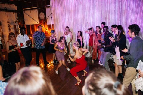 Alice Bessou, in red, and Stella Sepassipour dance in the middle of a dance circle during the American Prom for International Students on Thursday, April 25, 2019, at The Narrative Loft in Santa Barbara, Calif. The dance intended to introduce international student to the American prom experience.