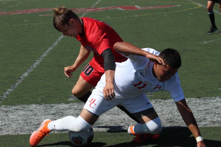 Christopher Robinson in red, forces the ball away from Omar Reyes-Madrid on Friday, Sept. 13 2019, on La Playa Field at City College in Santa Barbara, Calif. The Vaqueros beat Bakersfield 3-1.