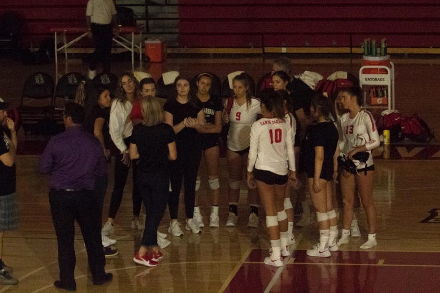 Vaquero volleyball players huddle around and wait for information about the power outage on Friday, Sept. 20, 2019, in theSports Pavilion at City College in Santa Barbara, Calif. The game was eventually canceled.