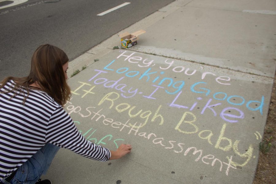 City College student Rebeca Adam chalks a quote from a sexual harassment story at Santa Barbara City College in Santa Barbara, Calif., on Thursday, Sept. 26, 2019. She chalks sidewalks at least three times a week to share stories of sexual harassment and assault that are messaged to her on her instagram, @catcallsofsantabarbara.