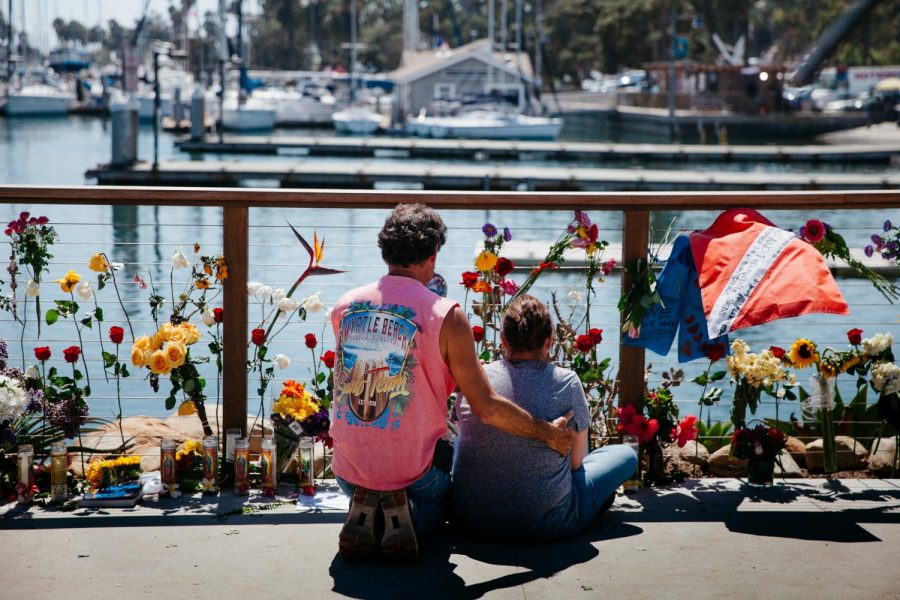 Cherie McDonough is comforted by a loved one while grieving the death of her 25 year-old daughter Alexandra Kurtz, at a memorial remembering the 34 victims killed in a boat fire on Tuesday, Sept 3, 2019 next to Sea Landing in Santa Barbara, Calif. “She followed her dream,” said McDonough, “This is where she was happy at.”