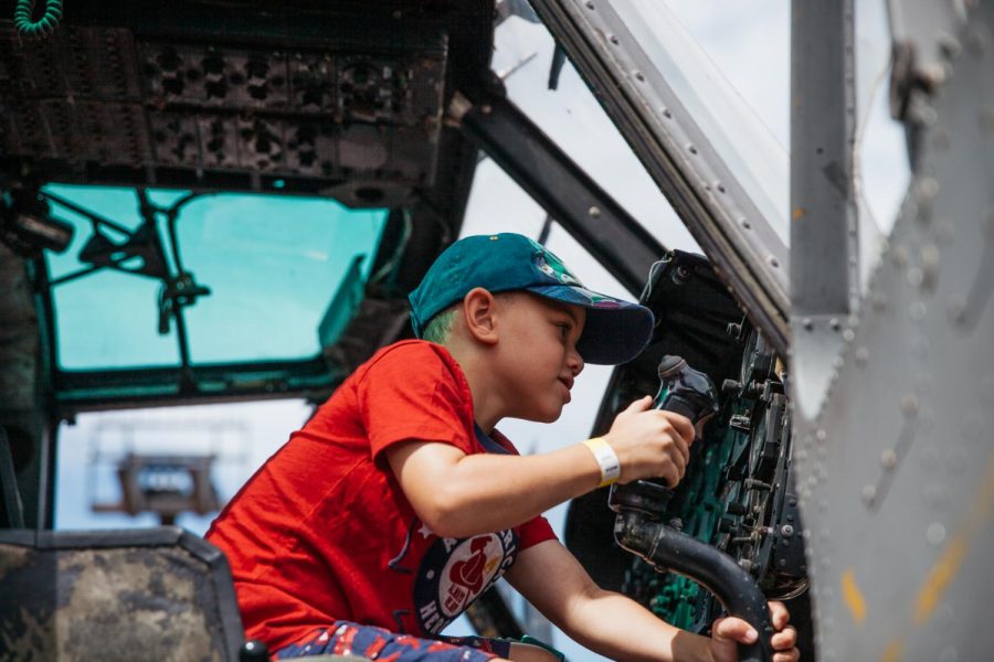 A local child fidgets with gadgets and controls of the retired UH-1M war helicopter brought to Touch a Truck day by the Vietnam Veterans of America Corporation on Sunday, Sept. 22, 2019, in the West Campus parking lot at City College in Santa Barbara, Calif. The twin blade chopper named Huey, was used in the Vietnam War as a gunship and donated to the VVA by Gerry Roberson.