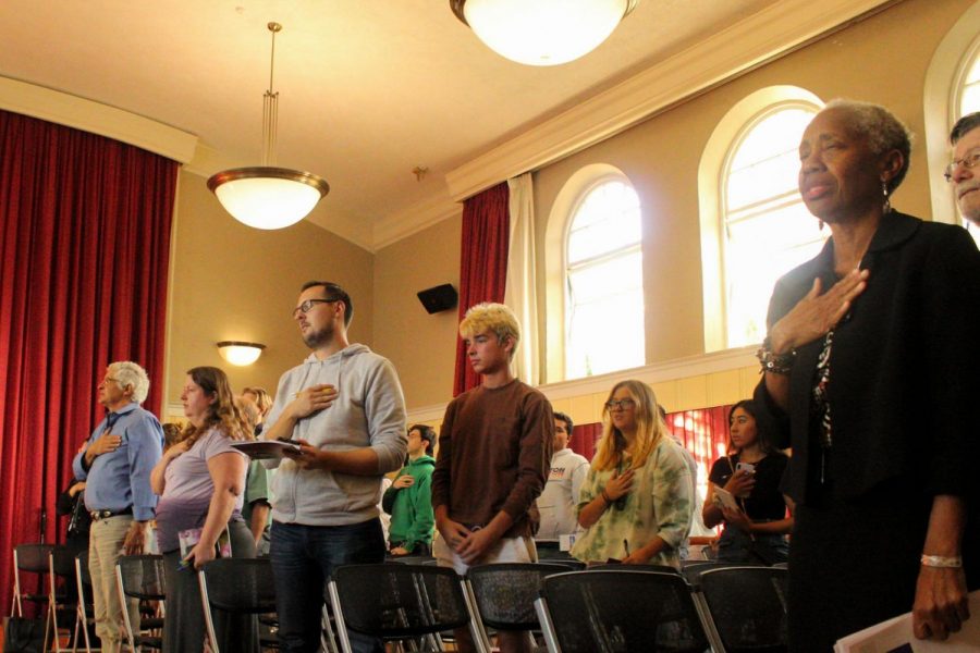 Helen Benjamin (right) stands for the Pledge of Allegiance along with students, board members and people of the community for the State of the College presentation to the community on Oct. 3, 2019, at the Schott Campus in the James Tannahill Auditorium in Santa Barbara, Calif.