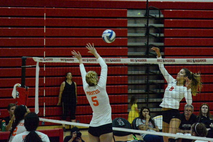 Makenzie+Phelps+%28No.+8%29+hits+the+ball+past+middle+blocker+Tatum+Teel+%28No.+5%29+during+the+third+set+of+the+Vaqueros+match+against+the+Pirates+on+Friday%2C+Oct.+4%2C+2019%2C+in+the+Sports+Pavilion+at+City+College+in+Santa+Barbara%2C+Calif.+The+Vaqueros+lost+3-1.