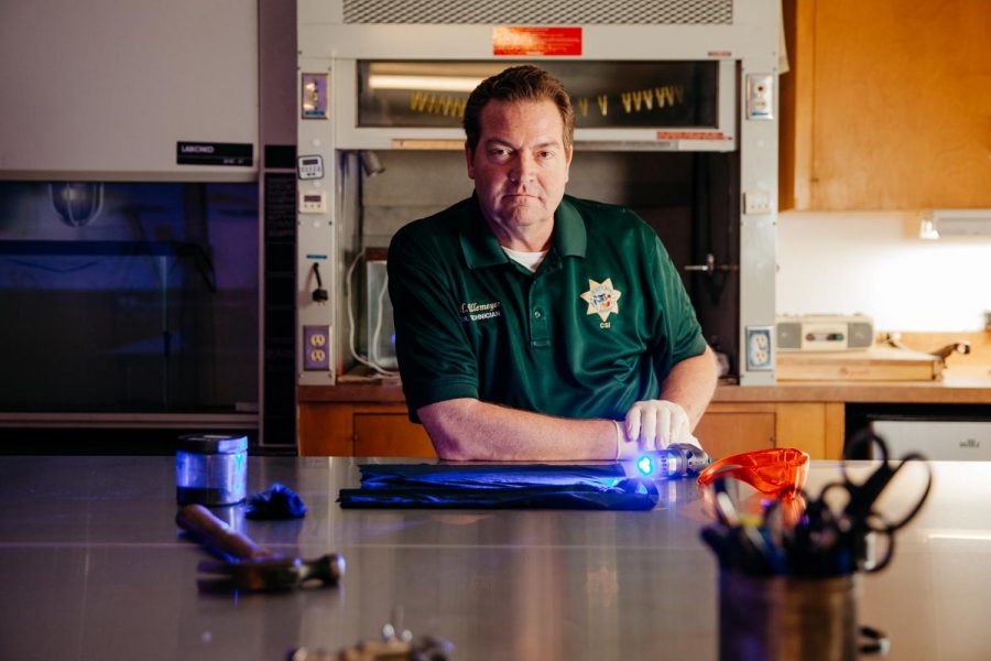 Senior Forensic Technician and adjunct City College Instructor Mike Ullemeyer sits with forensic analysis tools at the evidence table in the crime lab in the Sheriffs County Office on Friday, Oct. 25, 2019, in Santa Barbara, Calif. Ullemeyer teaches introduction to forensics at City College and has played key roles in the investigation of recent cases like the Conception boat fire and the Hope Ranch stabbing for the Sheriff’s Department.