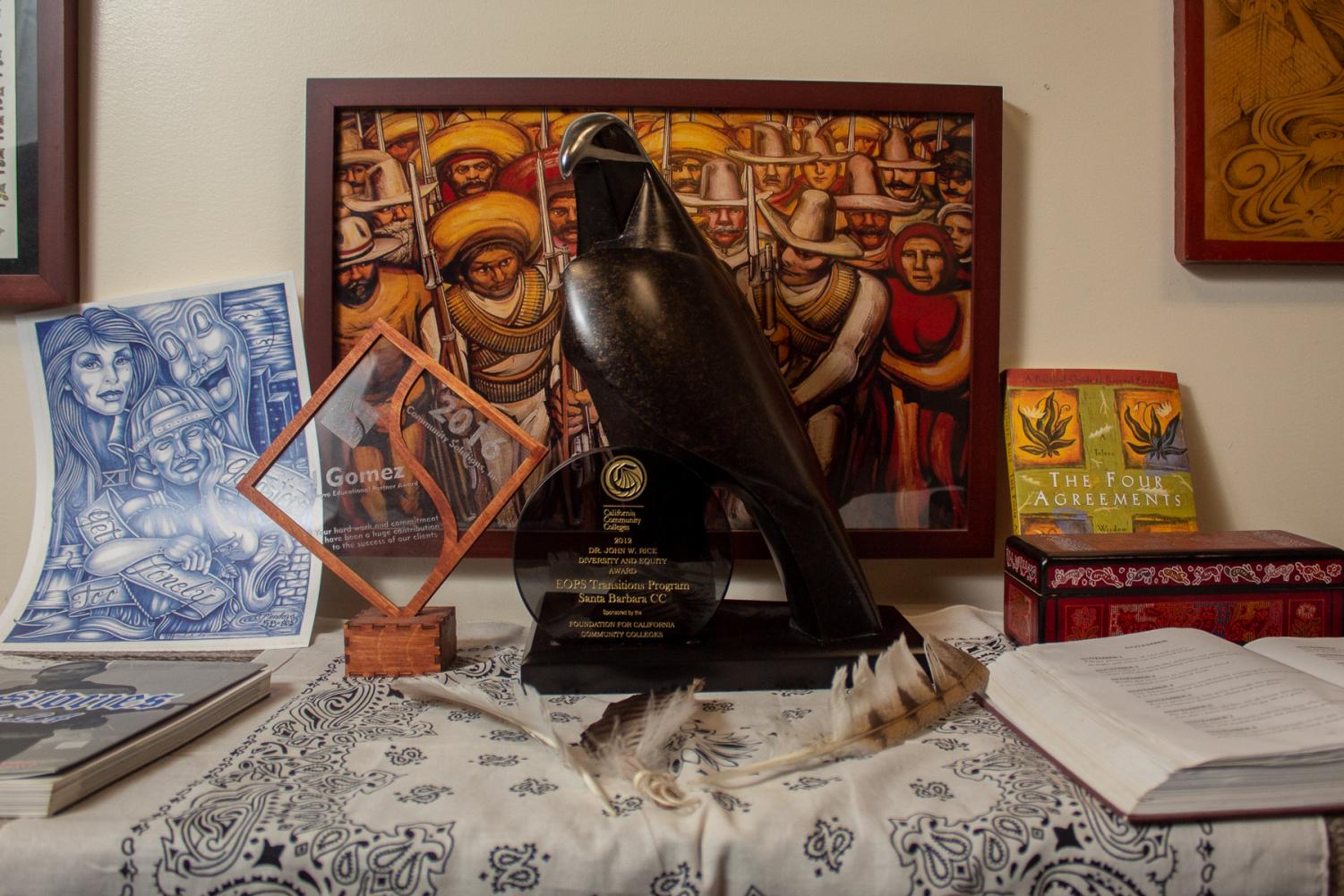 Some of Noel Gomez's awards and artwork in his office in the Student Services Building on Friday, Nov. 8, at City College in Santa Barbara, Calif. The hawk trophy (center) was awarded to EOPS for the transition program.