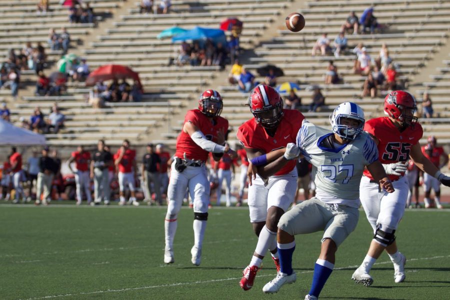 Quarterback Scotty Forbes (No.1) passes to the Vaqueros while his teammates, Will Bayonne (No.2) and Daniel Rivera (No.55), defend against the Spikes on Saturday afternoon, Nov. 2, 2019, at La Playa Stadium at City College in Santa Barbara, Calif. The Vaqueros lost their last home game 13-28 to the Allan Hancock College Spikes.