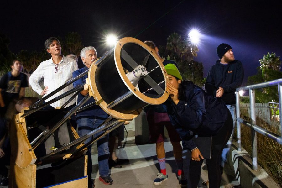 Astronomy Club member Mistea Adame follows a laser held by Robert Smith (second from right) with a Dobsonian telescope to locate and observe Jupiter on Friday, Nov. 22, 2019, on East Campus at City College in Santa Barbara, Calif. The Astronomy Club has been building the telescope for around 18 months and tested it with fellow City College students for the first time Friday.