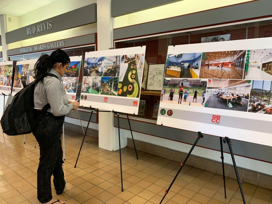 Paula Muñoz observes past project designs similar to the upcoming renovation of the Sports Pavillion on Wednesday, Nov. 13, 2019, in the Sports Pavilion at City College in Santa Barbara, Calif.