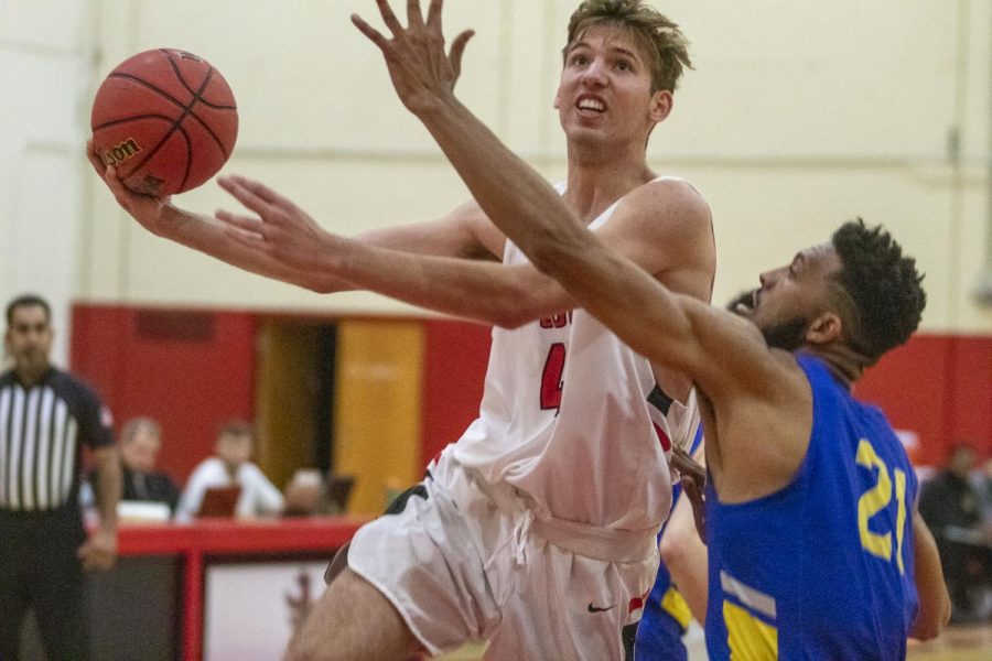 Calvin Winestock (No.42) goes for a layup against Sidney Bowen (No.21) on Wednesday, Jan. 22, 2020, in the Sports Pavilion at City College in Santa Barbara, Calif.