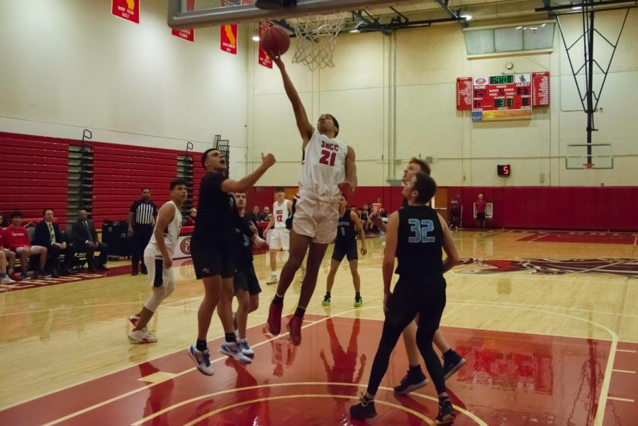 Adrian Juilland-Johnson (No. 21) puts up a lay-up past defenders during the first half of the game against the Moorpark College Raiders in the Sports Pavilion Gym on Wednesday, Jan. 29, 2020, at City College in Santa Barbara, Calif. The Vaqueros lost the game to the Raiders 96-66.