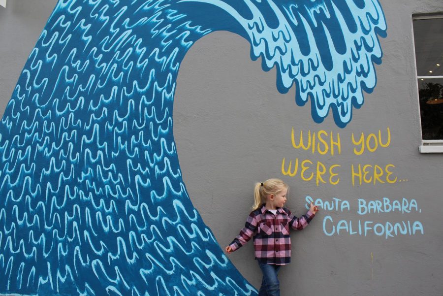 Rowan Kelly enjoys a mural done by local artist DJ Javier on Dec. 21, 2019 on Helena Avenue in the Funk Zone in Santa Barbara, Calif.