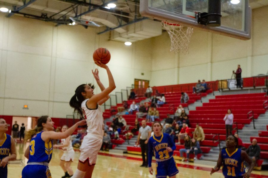 Sophia Torres (No. 12) shoots the ball over the hands of defenders during the home game against Allan Hancock on Wednesday, Feb. 5, 2020, at City College in Santa Barbara Calif. The Vaqueros won the game 77-67.