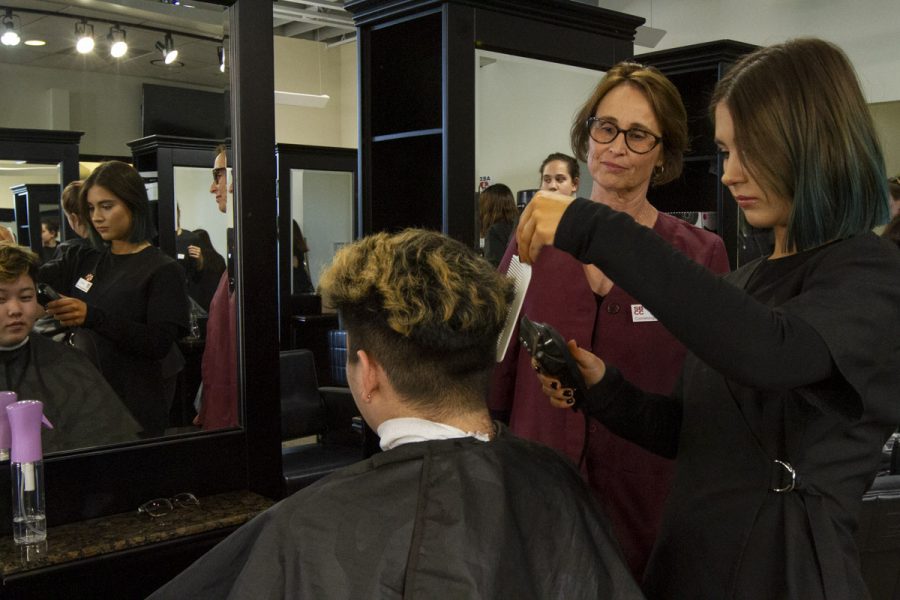 Head of the Cosmetology Academy Michelle Puailoa guides Alex Sugent in cutting fellow student Kenton Yamatakes hair on Feb. 5, 2020, at the City College Cosmetology Academy in Downtown Santa Barbara, Calif.