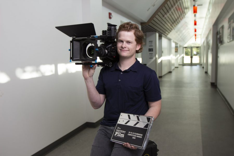 City College student Will Hahn sits in the hallway of one of his favorite buildings on campus, the Humanities building, holding the award for Best Director from the Santa Barbara Film festival with his camera on Feb. 18, 2020 at City College in Santa Barbara, Calif.