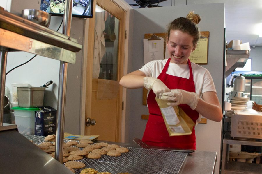 Siobhan Holden packages cookies to sell while chatting with her mom (not pictured) on Sunday, Feb. 2, 2020, in the shared kitchen of Santa Barbara Cookie Company and the Lemon & Coriander restaurant in Goleta, Calif.