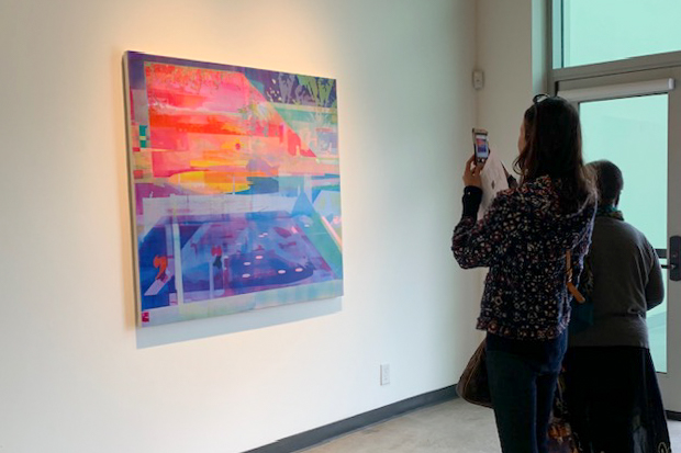 City College student Patricia Kaneb, photographs and admires “Prism and Lens” by Zoe Walsh on Friday, Feb. 21, 2020 in the Atkinson Gallery at City College in Santa Barbara, Calif.