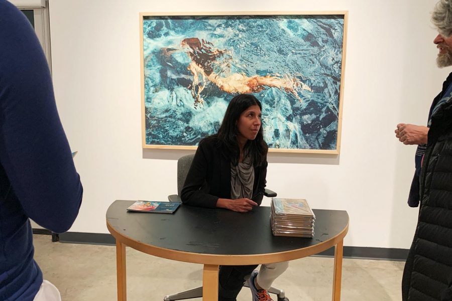 Artist Manjari Sharma signs her book Darshan for audience members in front of her work featured in the first part of Eleven Figures in Two Parts” on Wednesday, Feb. 26 in the Atkinson Gallery at City College in Santa Barbara, Calif.