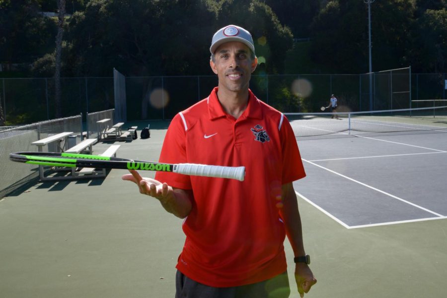 Tennis Coach Nathan Jackmon spins a racquet on one finger as his team warms up to play a match against Orange Coast College at Pershing Park on Feb. 7, 2020, in Santa Barbara, Calif.