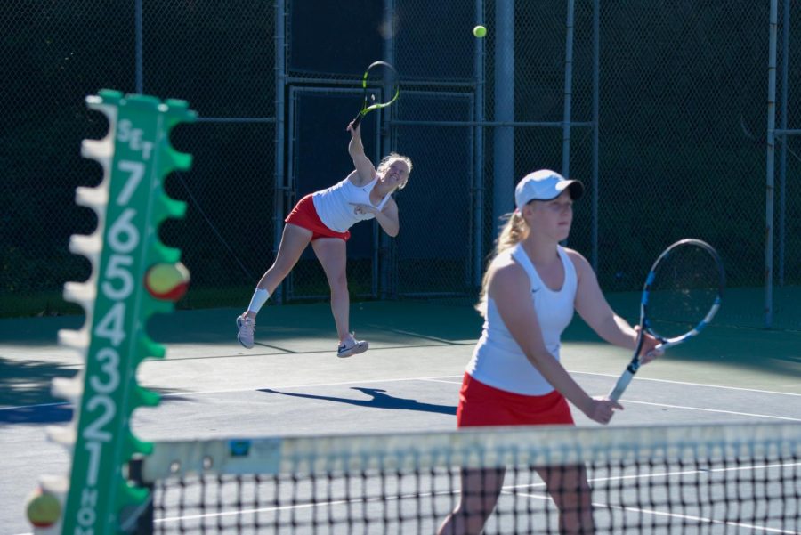 Joica Buyse serves the ball as her sister Jamaica Buyse waits at the net during a doubles match against Santa Monica College Corsairs at Pershing Park on Tuesday, Feb. 11, 2020 in Santa Barbara, Calif. The Buyse twins won their match 8-1 and the Vaqueros swept the Corsairs 9-0.