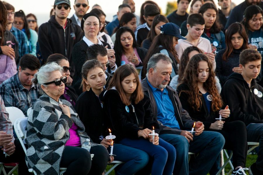 Adolfo and Mary-Jane Becerra Corrals four children sit in the front row holding candles for the Vigil remembering their parents on Wednesday, Feb. 12, on the West Campus Lawn at City College in Santa Barbara, Calif. Several hundred people gathered to honor the Corrals and listen to family, friends and co-workers speak.