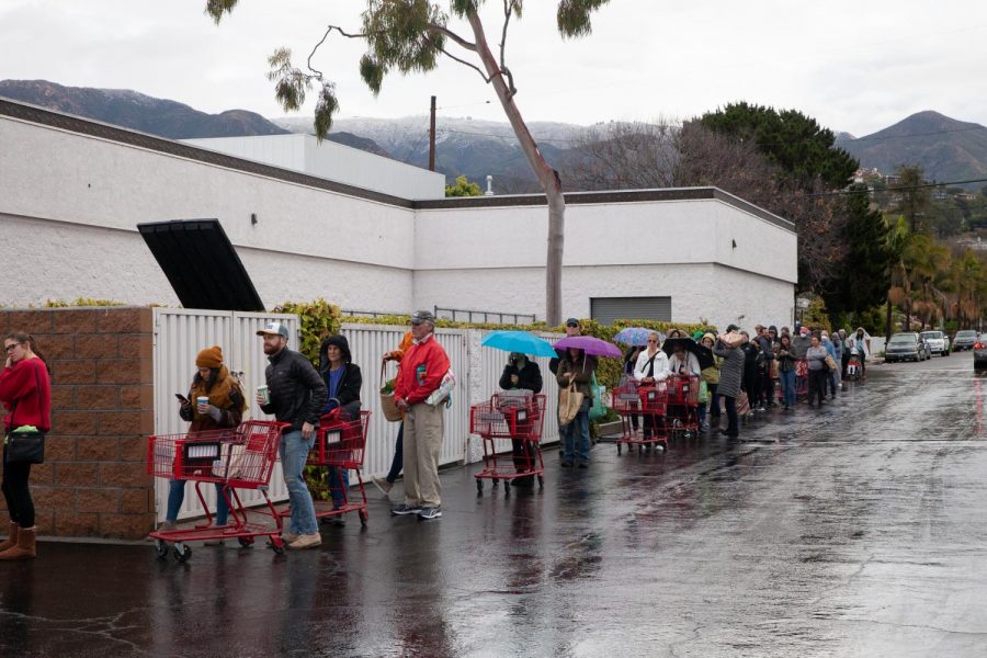Shoppers line up around Trader Joes’s to prepare for social distancing as the grocery chain limits the capacity of shoppers from 10-25 at a time on Tuesday morning, March 17, 2020, at Trader Joe’s on N Milpas Street in Santa Barbara, Calif.