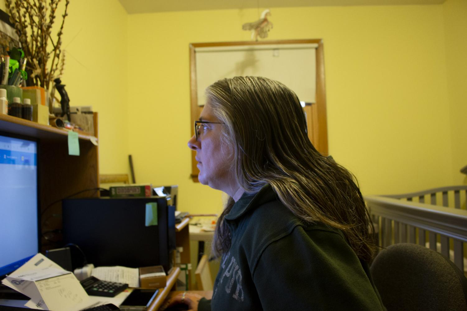 Terese Brunner works on filling out unemployment forms after losing her jobs due to the shelter in place order on April 6, 2020, at her home in New Holstein, Wis. Two out of her three jobs have already asked her to come back when it is safe to do so.