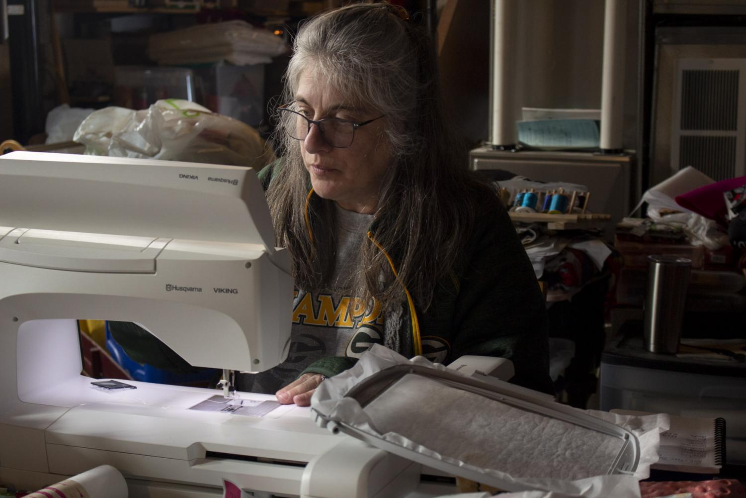 Terese Brunner changes the bobbin on her embroidery/sewing machine on April 2, 2020 at her home in New Holstein, Wis. Brunner is taking advantage of free time and has been testing out new embroidery designs and finishing up a baby blanket for her expecting goddaughter.