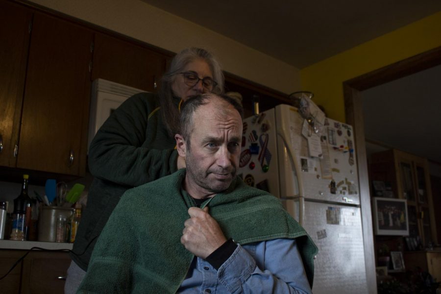 Terese Brunner cuts Mitch Schrage’s hair at home while barber shops remain closed in the area on April 15, at their home in New Holstein, Wis. Schrage occasionally gets his haircut at a barbershop and usually has Brunner trim his hair in-between visits.