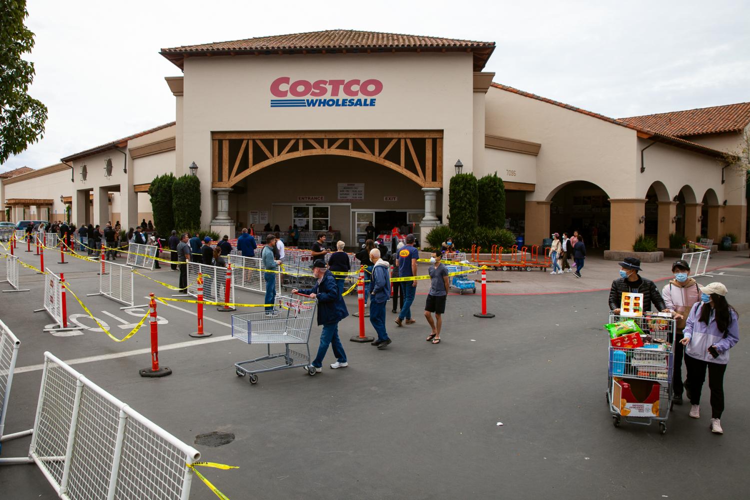 Shoppers lineup outside Costco the morning after Gavin Newsom issued a state wide shelter-in-place order on Friday, March 20, in Goleta, Calif. Costco limits its capacity to 50 shoppers at a time. 