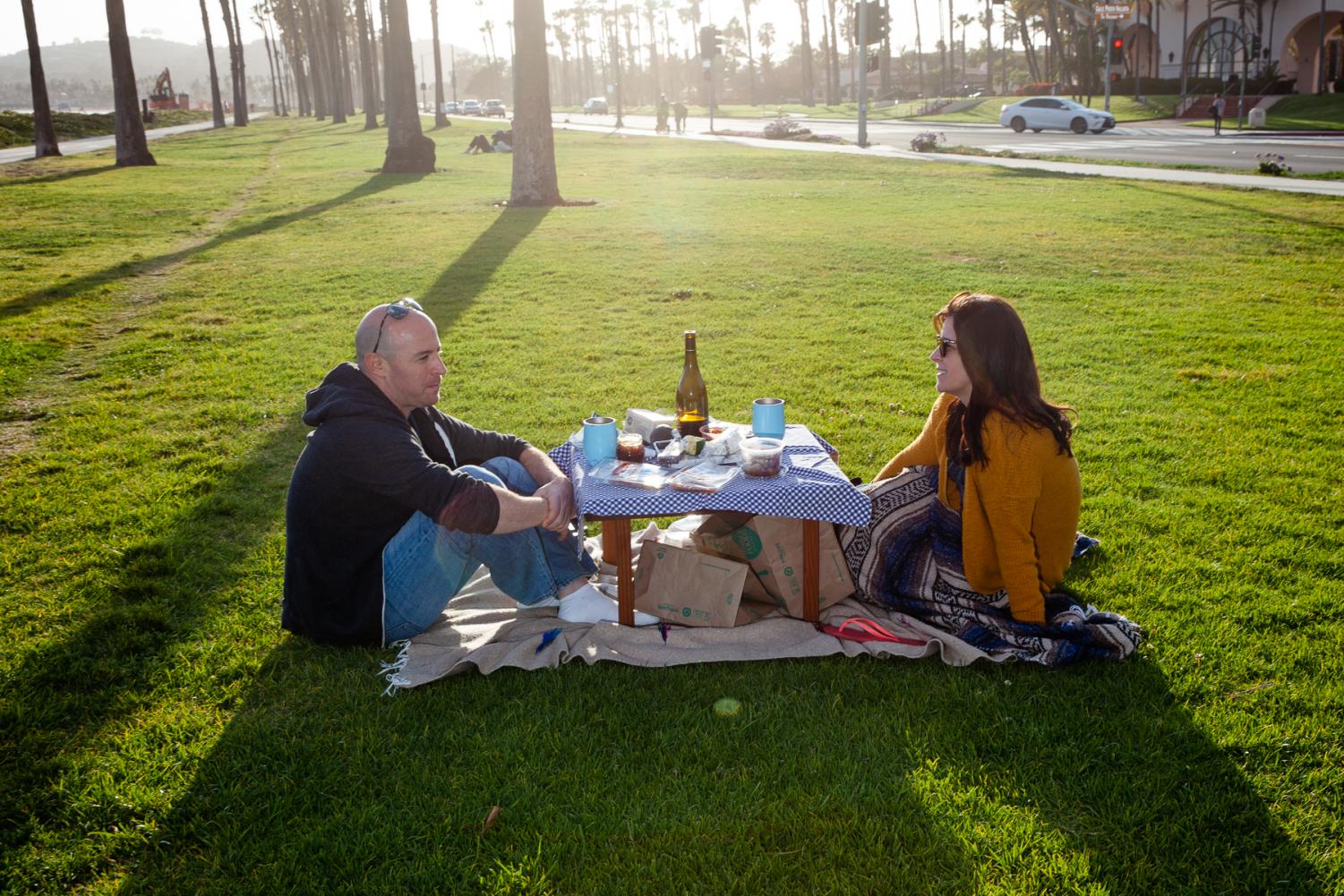  As restaurants close or offer take-out only Nate Tackerman and Jenny Brice share a picnic at Chase Palm Park to get out of the house on Saturday, April 4, in Santa Barbara, Calif. “We’re just hanging out here since everything is pretty much closed,” Tackerman said. 