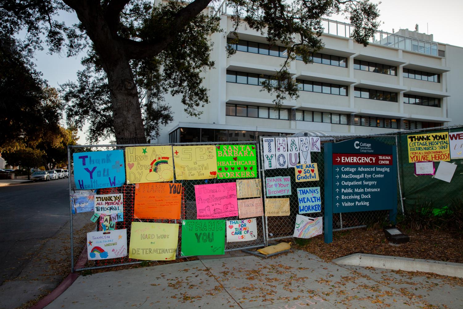 A collection of posters thanking medical workers decorate a construction fence surrounding the eastern quarter of Cottage Hospital in Santa Barbara, Calif. 