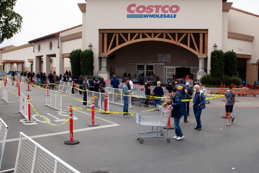 Shoppers lineup outside Costco the morning after California Gov. Gavin Newsom issued a statewide shelter-in-place order on Friday, March 20, in Goleta, Calif. Costco limits its capacity to 50 shoppers at a time.