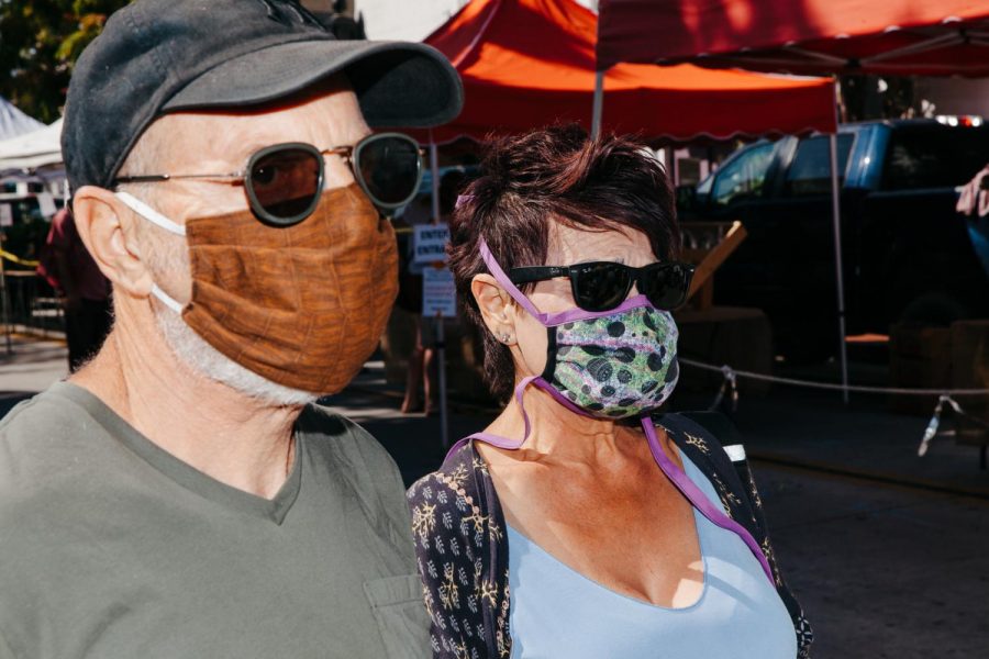 Peter and Naomi Pavia in homemade masks stitched by Naomi on Tuesday, April 21 in Downtown Santa Barbara, Calif. Naomi Stitches masks to donate to friends, neighbors and nursing homes while Peter thinks the virus is exaggerated, but wears a mask to be courteous to others.