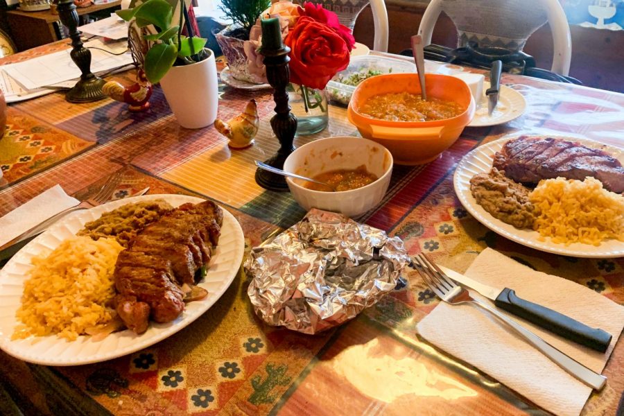 Savory New York steak over grilled onions and peppers with a side of rice and beans is a family favorite. The table is also packed with everything needed for the best tacos, tortillas, homemade salsa, queso fresco and a cilantro/onion mix to top them off.