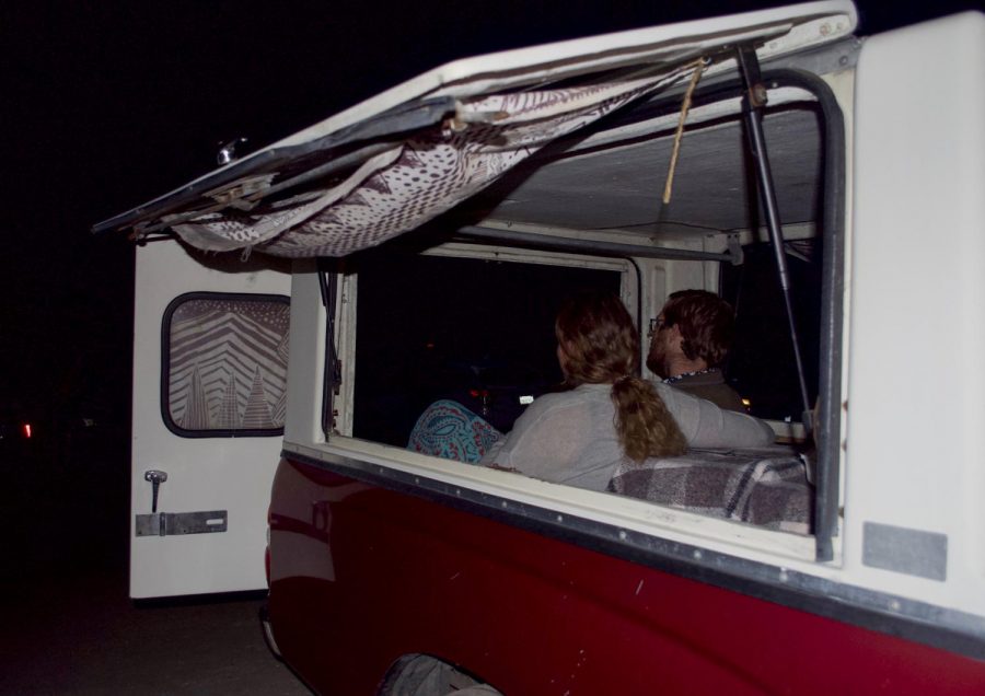 A couple sits in the backseat of their car as they watch the screening of the Patagonia documentary Public Trust. at the West Wind Drive-In, Sept. 23, 2020, in Santa Barbara, Calif.
