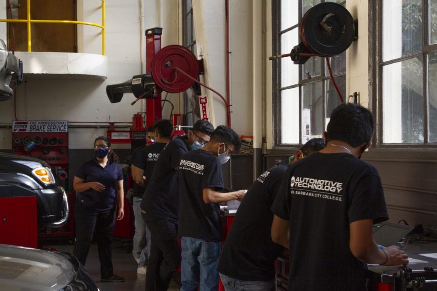 City College Automotive Technology students listen for directions from their instructor Brittanye Muschamp for the next steps on their in-class worksheet on Oct. 8 at City College in Santa Barbara, Calif. The Automotive field is classified as an essential business making the lab portion of the Automotive Technology departments teaching at City College allowed to be in-person.