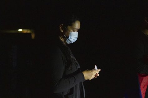 Antonia Robles Claudio, Nicholas Claudio Aunt, bows her head in a moment of silence in between speakers at her nephew's vigil on Oct. 3 at Sands Beach in Isla Vista, Calif. Antonia flew all the way from Massachusetts the day of just in time for the vigil.