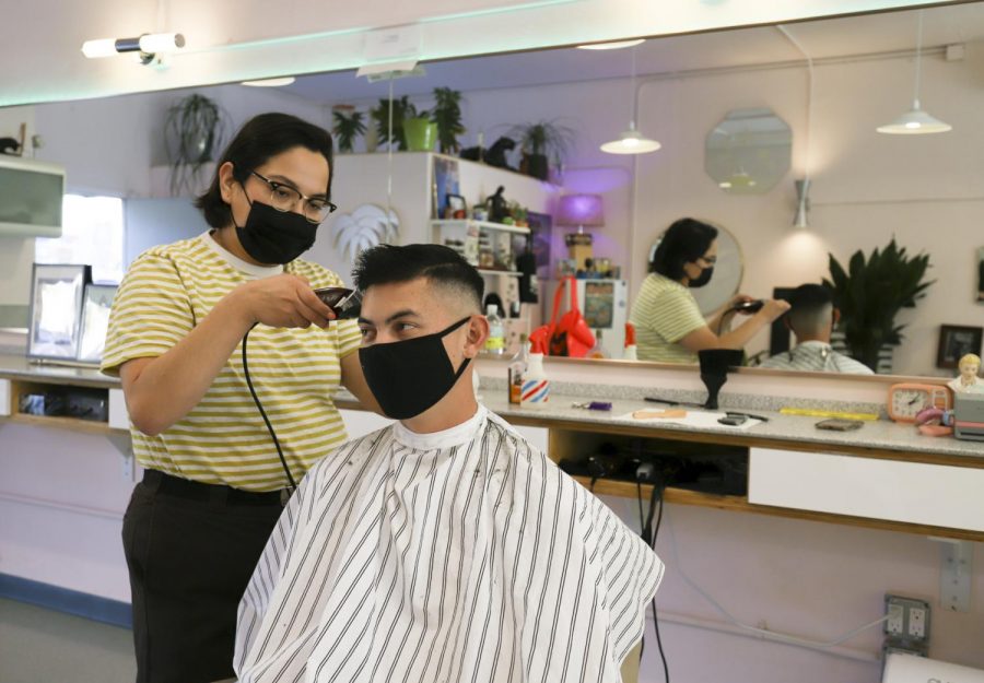 Erin Guereña trims up long-time returning client Tyler Silvestres hair on Nov. 19, 2020 at Haven Barber Shop at 1924 De La Vina St. in Santa Barbara, Calif. “I dont even need to look at it,” Silvestre said to Guereña. “Your hair cuts are perfect every time.”