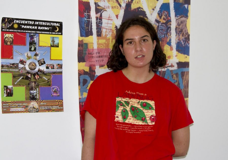Ili Levine stands in her home next to a picture from the traditional ceremony she participated in during her trip to Ecuador, on Nov. 4, 2020, in Santa Barbara, Calif. Levin started her non-profit Ayudantes International after a trip to Ecuador last year where she witnessed how many people could not afford to feed their families for the day.