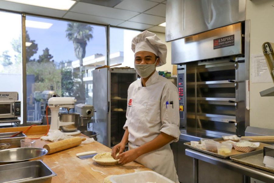 Zuberi Sharp, a first-year City College student, crimps the pie crust before placing it in the 
freezer to harden on Nov. 24, 2020, in the kitchen of the cafeteria at City College in Santa Barbara, Calif. Chef Stephane Rapp said that “the energy has been extra positive” because of students like Sharp. 
