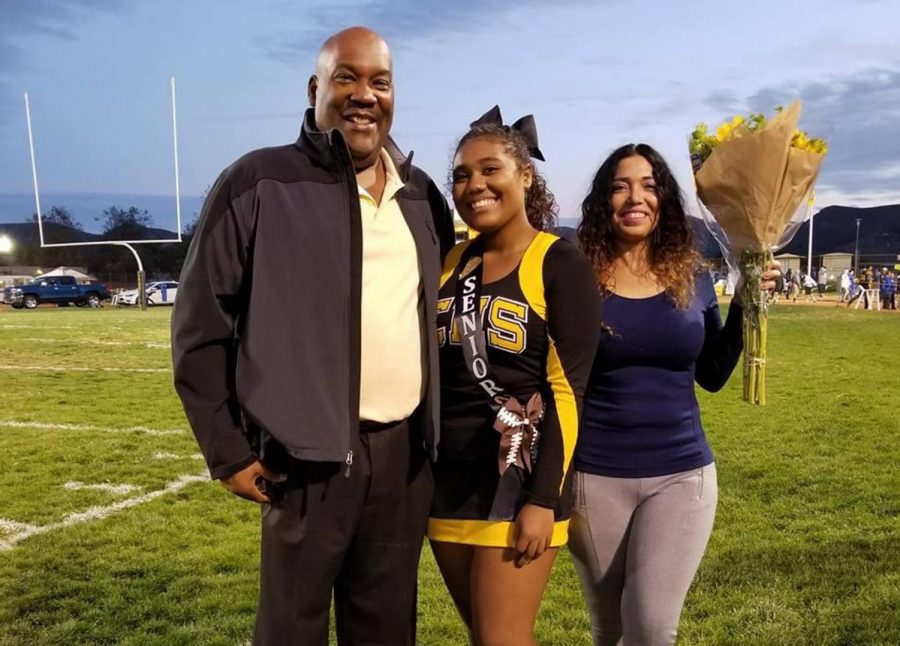 Cassandra Wilkins with her parents Smiley Wilkins, Jr. (left) and Maribel Santos Wilkins during senior night on Nov. 3, 2017, in Lompoc, Calif.