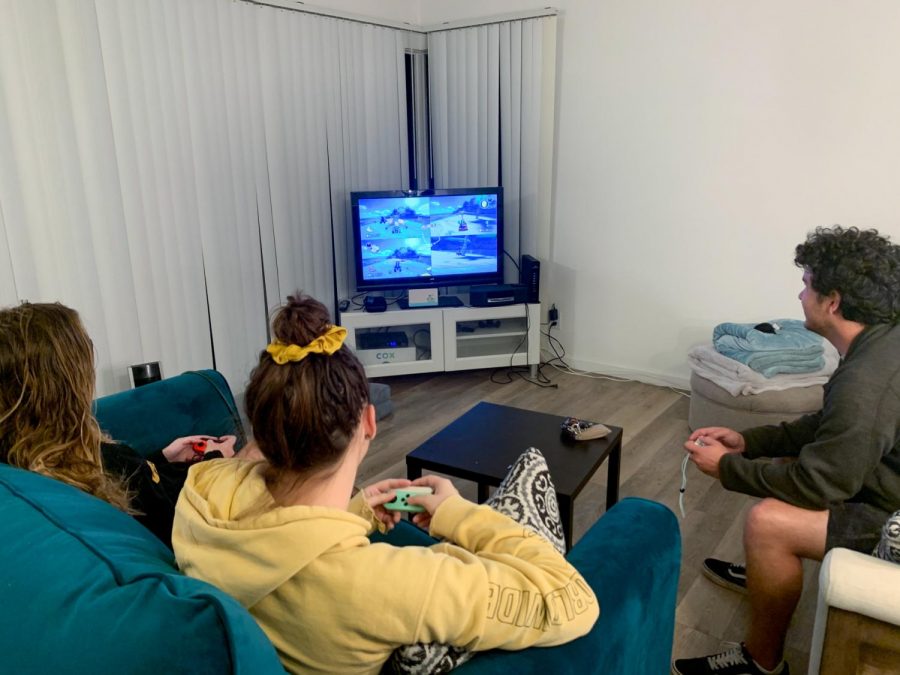 From left, Zoe St. Pierre, Evelyn Spence, and Joseph Kolda play Mario Kart 8 on a Nintendo Switch from their home on Feb. 4 in Isla Vista, Calif. Mario Kart 8 is a family-friendly game that all ages can enjoy playing.