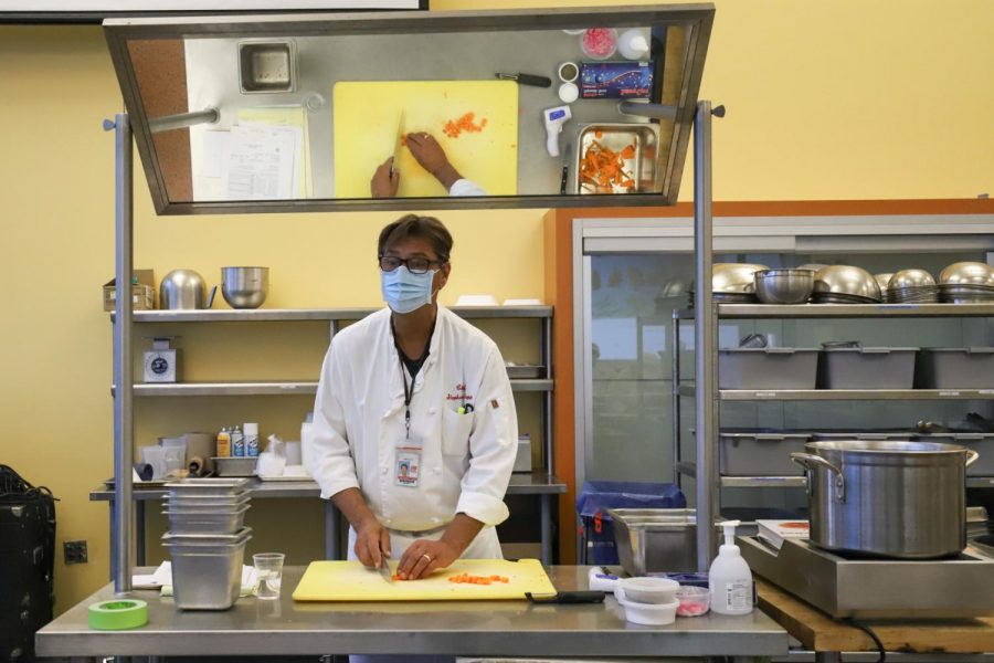 Chef Stephane Rapp teaches his Principles of Pantry class how to cut a carrot from his teaching station at the front of a socially distanced class where each student has his or her own workstation on Jan. 25, 2021 in the cafeteria where the culinary department is temporarily holding classes at City College in Santa Barbara, Calif. Chef Rapp originally came to America in the 80’s and ultimately stayed because of his passion for culinary education.