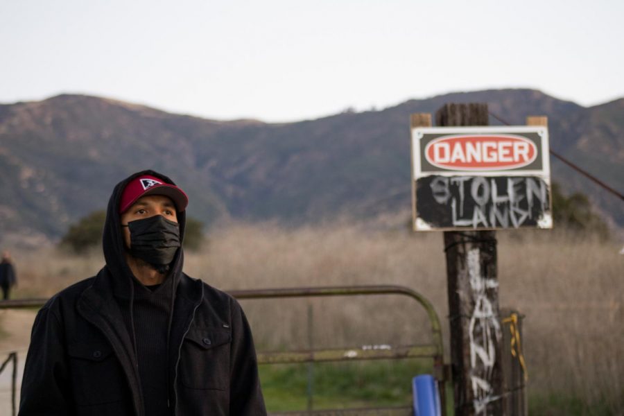 Protester Roy Schulte watches the scene at the sit-in protest on Feb. 26, 2021, at the San Marcos Foothills Preserve in Santa Barbara, Calif. Schulte stayed overnight in support of those trying to protect the land from development.