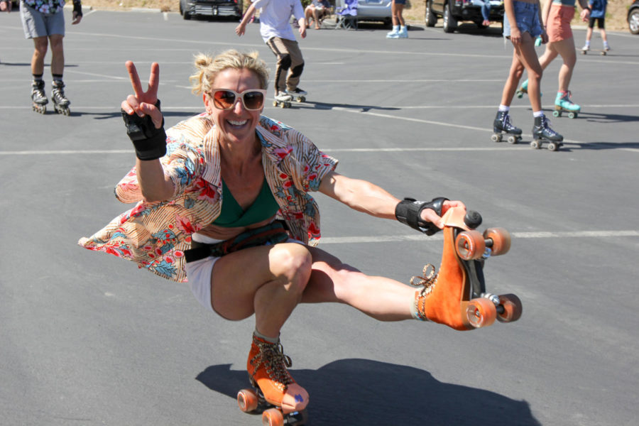 Andrea Strand does the "shooting the duck" position on March 21, 2021 in Lot 3 at City College in Santa Barbara, Calif. SB Rollers meets every Sunday afternoon at the parking lot to skate together.