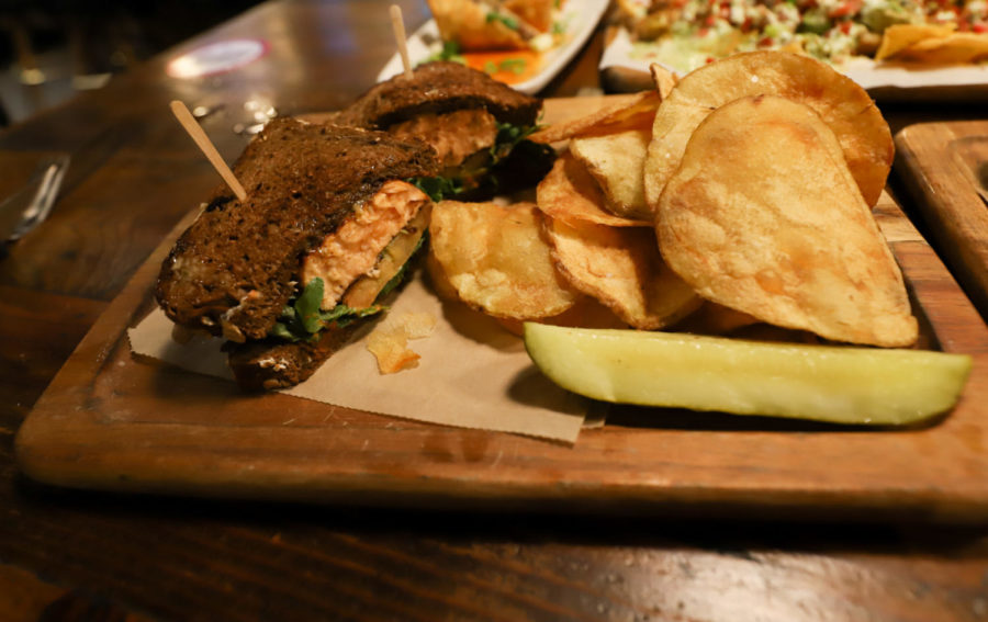 The King Salmon sandwich with homemade potato chips and a pickle slice, one of many health-conscious options available at Finney's Crafthouse & Kitchen.